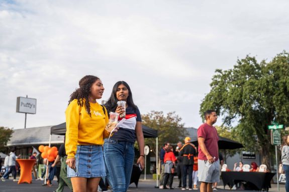 students walking on miracle mile drinking boba